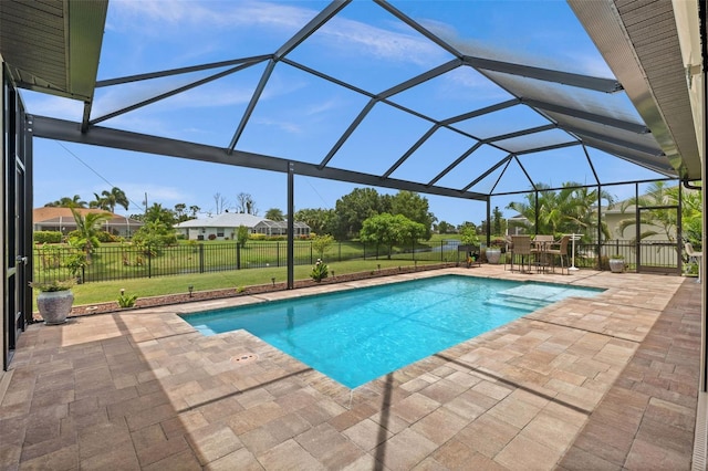 view of pool featuring a patio and glass enclosure