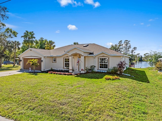 ranch-style house featuring a water view, a garage, and a front yard