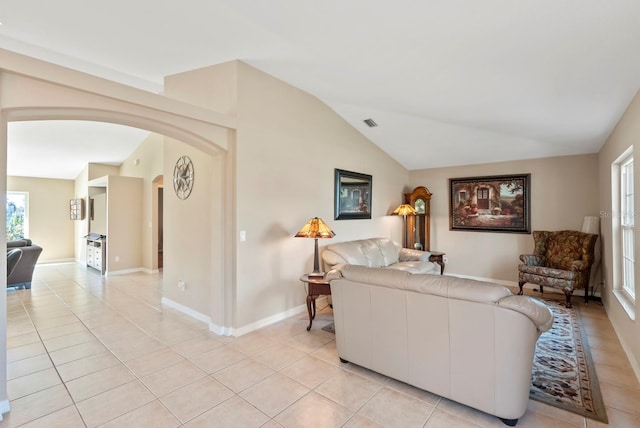 living room with vaulted ceiling and light tile patterned floors