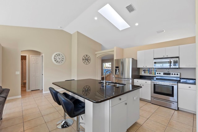 kitchen featuring stainless steel appliances, sink, a center island with sink, and light tile patterned floors