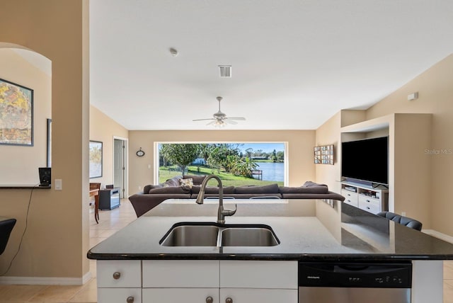 kitchen featuring sink, a kitchen island with sink, white cabinets, vaulted ceiling, and stainless steel dishwasher