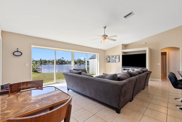 tiled living room featuring ceiling fan and lofted ceiling