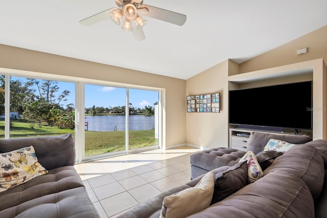 living room with ceiling fan, vaulted ceiling, and light tile patterned floors