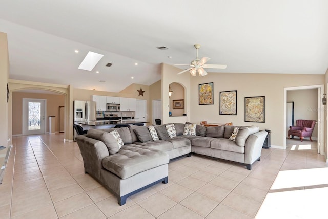 living room with light tile patterned flooring, ceiling fan, sink, and vaulted ceiling