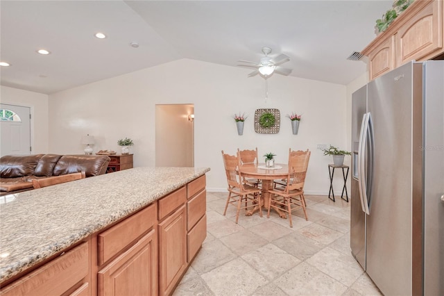 kitchen with light brown cabinetry, stainless steel fridge with ice dispenser, vaulted ceiling, and ceiling fan