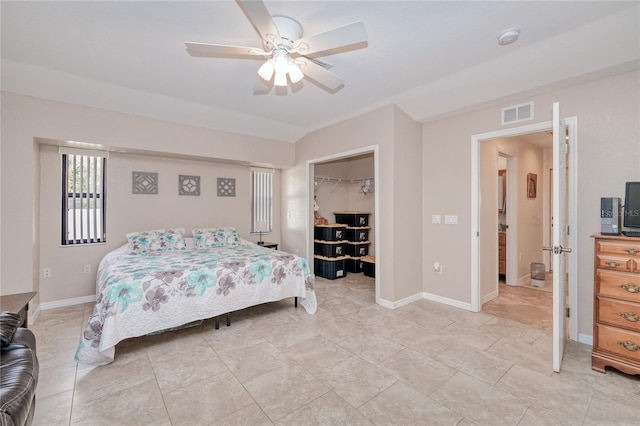 bedroom with a walk in closet, lofted ceiling, ceiling fan, and a closet