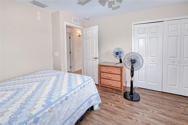 bedroom with wood-type flooring, a closet, and ceiling fan