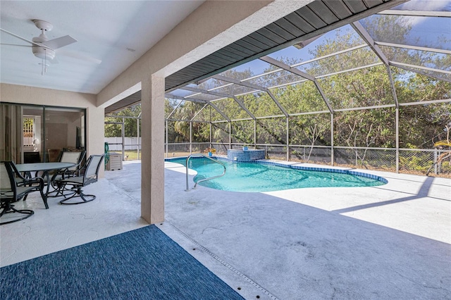 view of swimming pool with ceiling fan, a lanai, and a patio