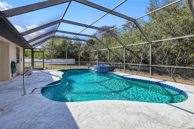 view of pool with a patio area and glass enclosure