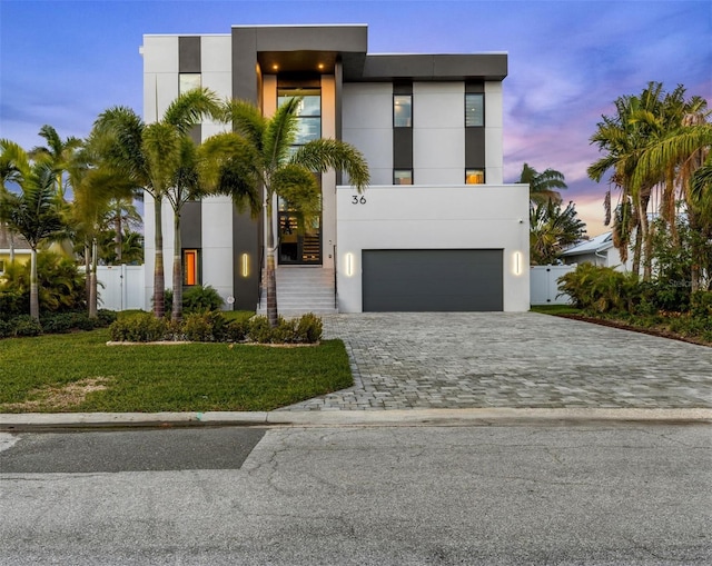 contemporary house with a garage and a lawn