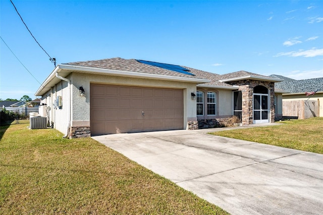 view of front facade with central AC, a garage, and a front lawn