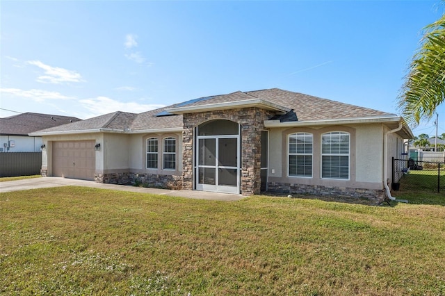 view of front of house featuring a garage and a front lawn