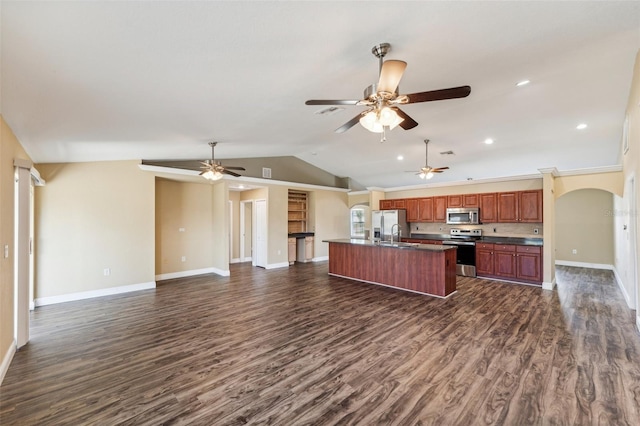 kitchen featuring appliances with stainless steel finishes, dark hardwood / wood-style floors, lofted ceiling, sink, and a center island with sink