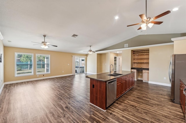 kitchen with lofted ceiling, sink, stainless steel appliances, an island with sink, and dark hardwood / wood-style flooring