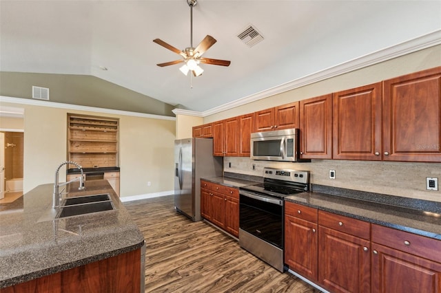 kitchen featuring sink, appliances with stainless steel finishes, dark hardwood / wood-style floors, tasteful backsplash, and vaulted ceiling