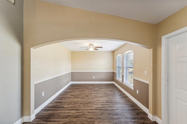 spare room featuring dark wood-type flooring and ceiling fan