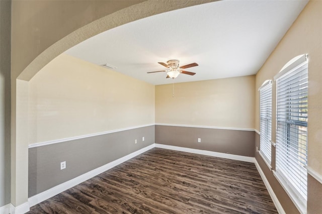 empty room featuring ceiling fan and dark hardwood / wood-style flooring