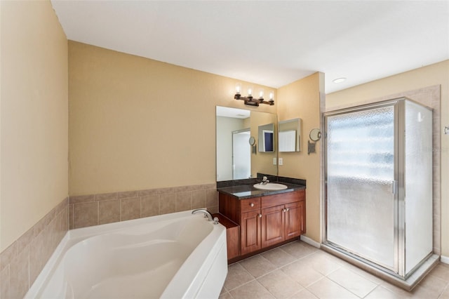 bathroom featuring vanity, tile patterned flooring, and shower with separate bathtub