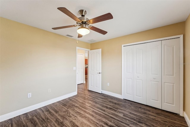 unfurnished bedroom featuring dark wood-type flooring, ceiling fan, and a closet