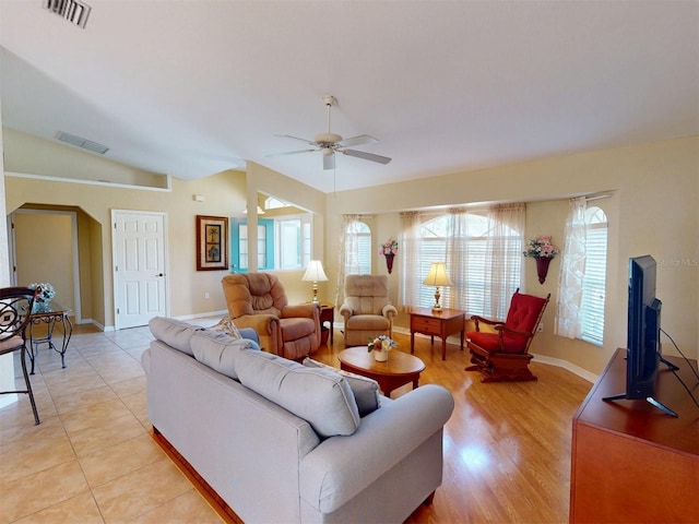 tiled living room featuring vaulted ceiling and ceiling fan