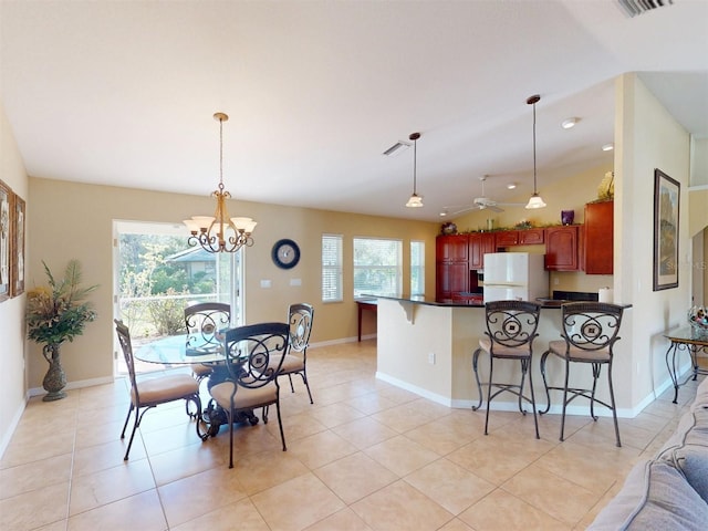 dining room with light tile patterned flooring, lofted ceiling, and ceiling fan with notable chandelier