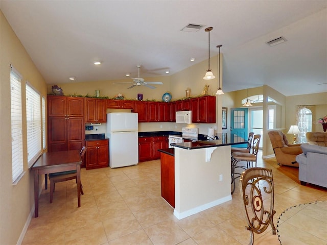 kitchen with lofted ceiling, a kitchen bar, hanging light fixtures, ceiling fan, and white appliances