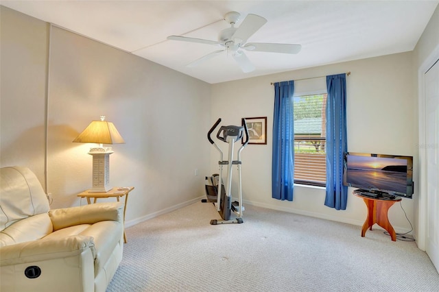 workout room featuring ceiling fan and light colored carpet