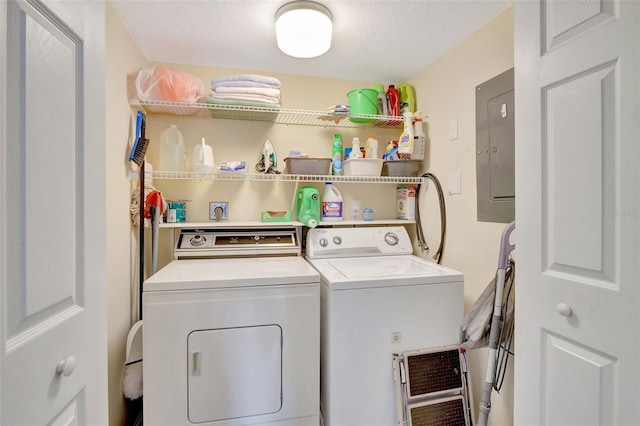 washroom featuring electric panel and washing machine and clothes dryer