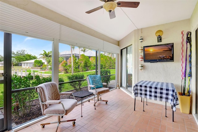 sunroom featuring vaulted ceiling and ceiling fan