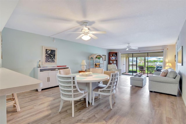 dining area with ceiling fan and light hardwood / wood-style flooring