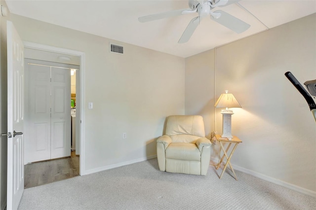 sitting room with light carpet and ceiling fan