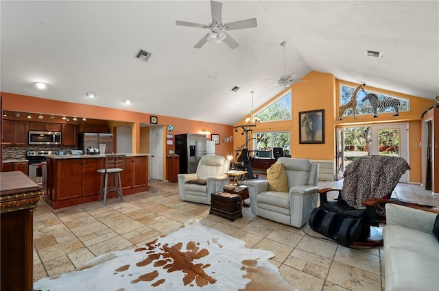 living room with high vaulted ceiling, visible vents, stone tile floors, and a ceiling fan