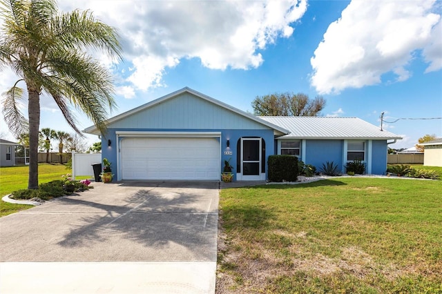 single story home with a garage and a front lawn