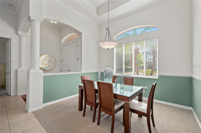 tiled dining area featuring ornate columns and ornamental molding