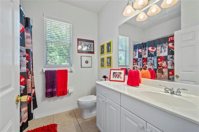 bathroom featuring vanity, toilet, tile patterned floors, and a healthy amount of sunlight