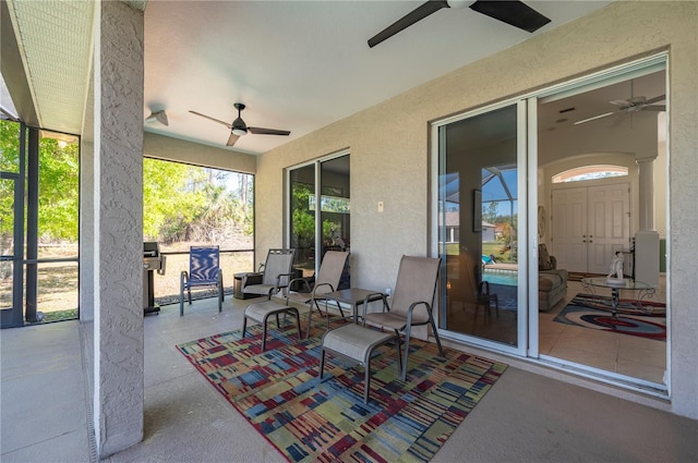 view of patio with ceiling fan and a lanai