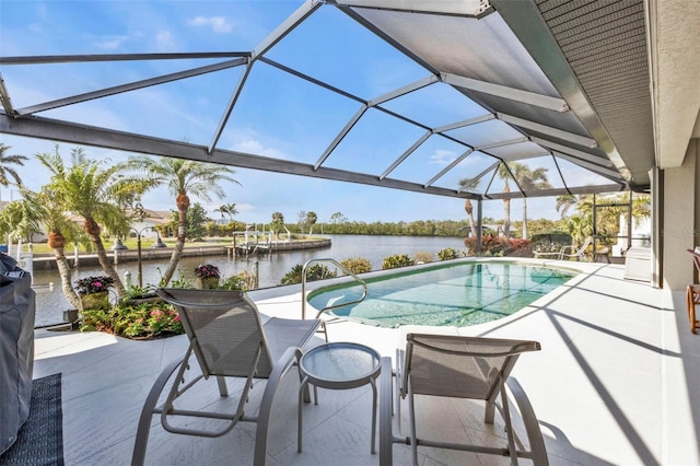 view of swimming pool with a lanai, a patio, and a water view