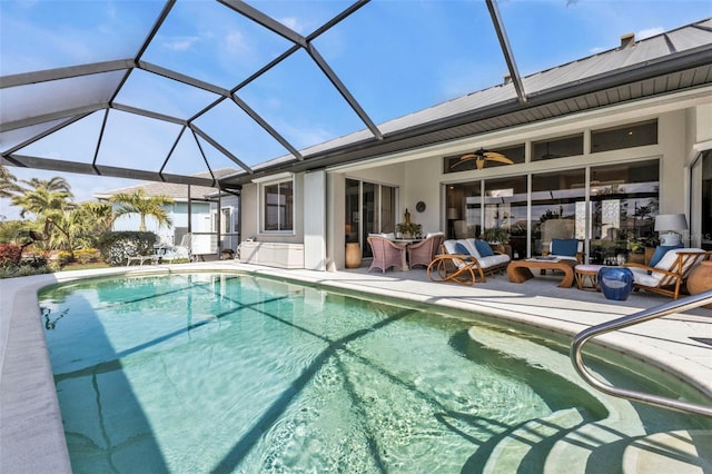 view of pool with a lanai, a patio, and ceiling fan