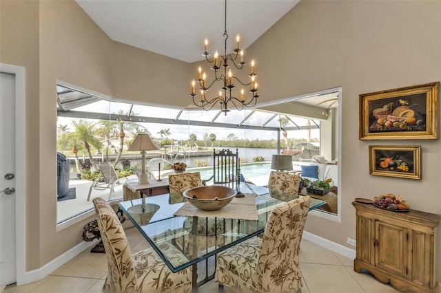 tiled dining room featuring high vaulted ceiling and a water view