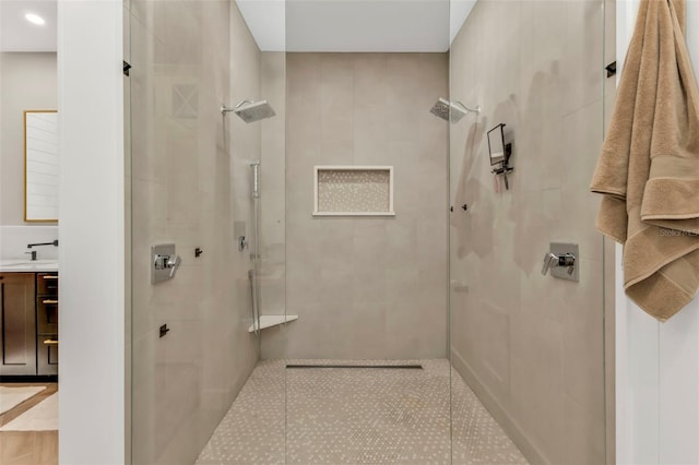 bathroom featuring vanity and a tile shower