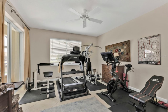 exercise room with ceiling fan and light tile patterned flooring