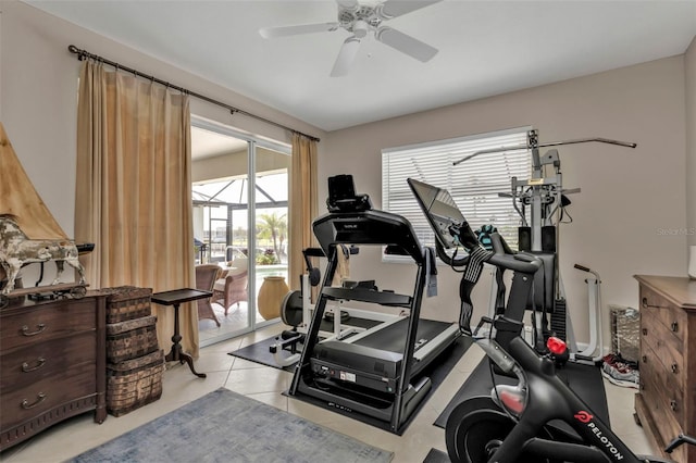 workout area featuring light tile patterned floors and ceiling fan