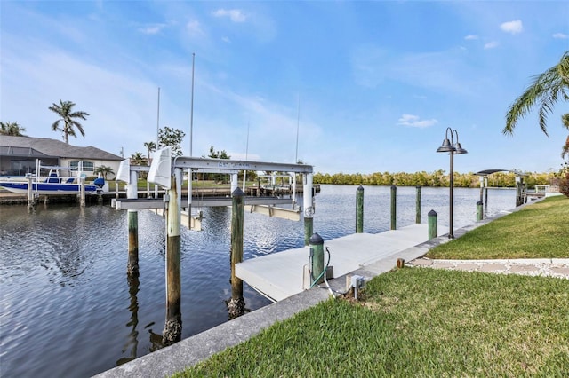 dock area featuring a water view and a lawn