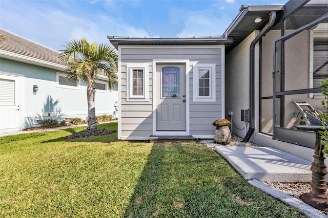 property entrance with a yard