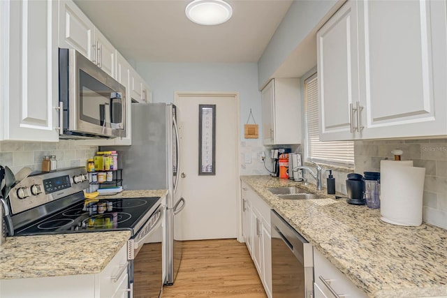 11369 1st Ave, Punta Gorda, FL 33955 - kitchen featuring sink, light hardwood / wood-style floors, white cabinets, and appliances with stainless steel finishes