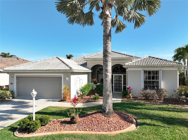 mediterranean / spanish home with a garage and a front yard