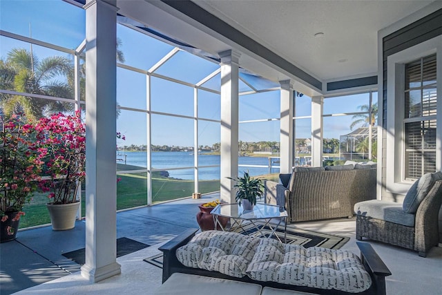 view of patio / terrace with glass enclosure and a water view