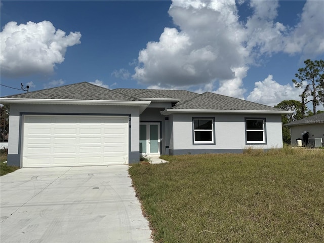 view of front of property featuring a garage, a front yard, and french doors