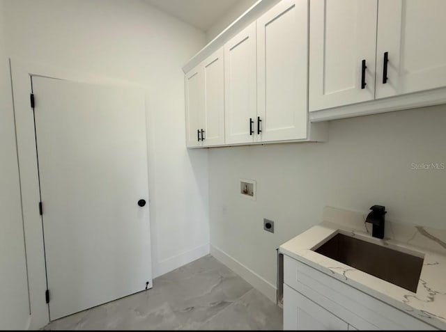 washroom featuring electric dryer hookup, sink, washer hookup, and cabinets