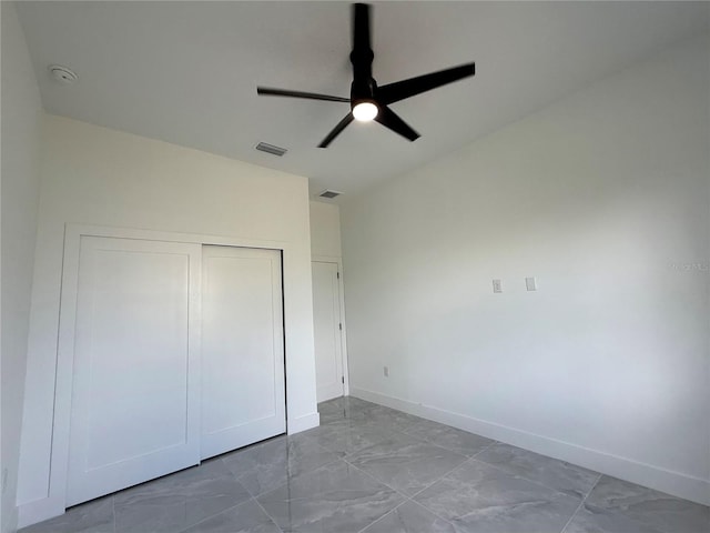 unfurnished bedroom with a closet and ceiling fan